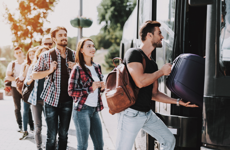 A photo of travelers getting on a bus.