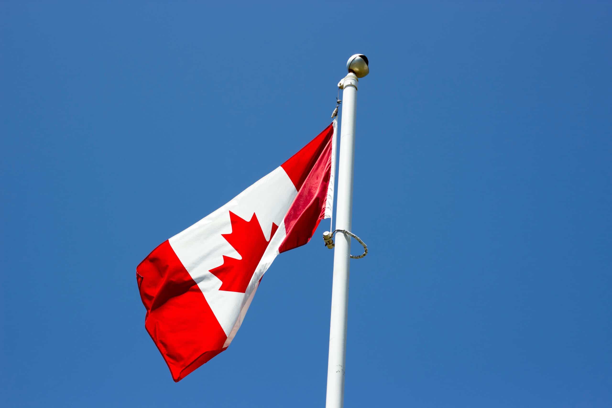 Canadian flag with a blue sky background